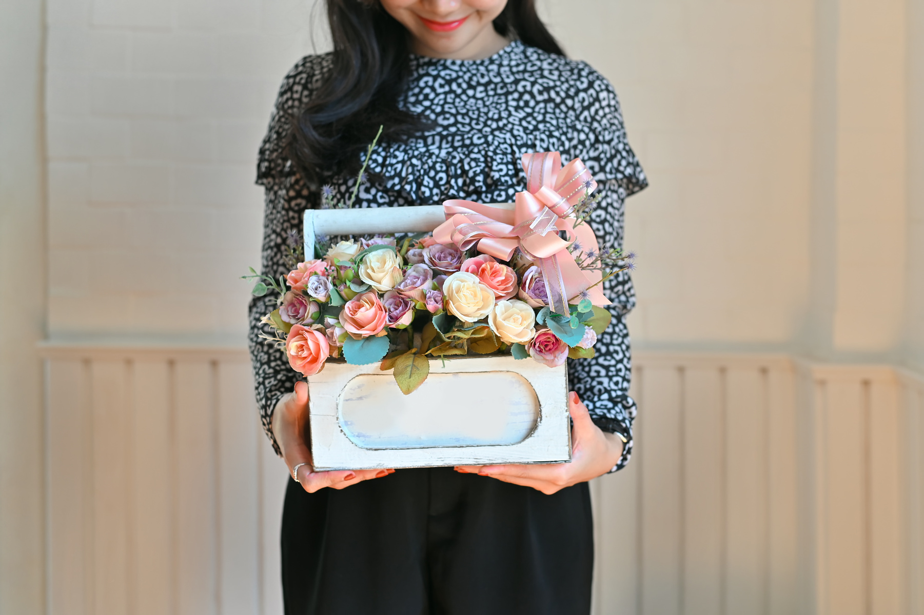 Woman giving a flower basket.